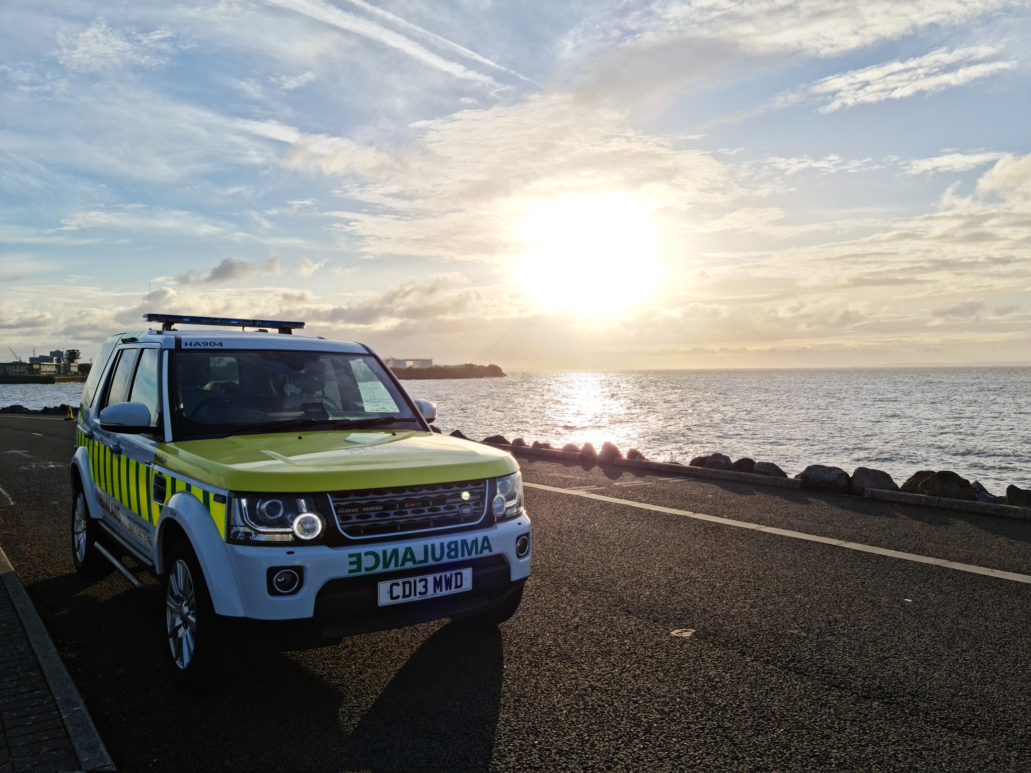 st john ambulance cymru in front of a sunset